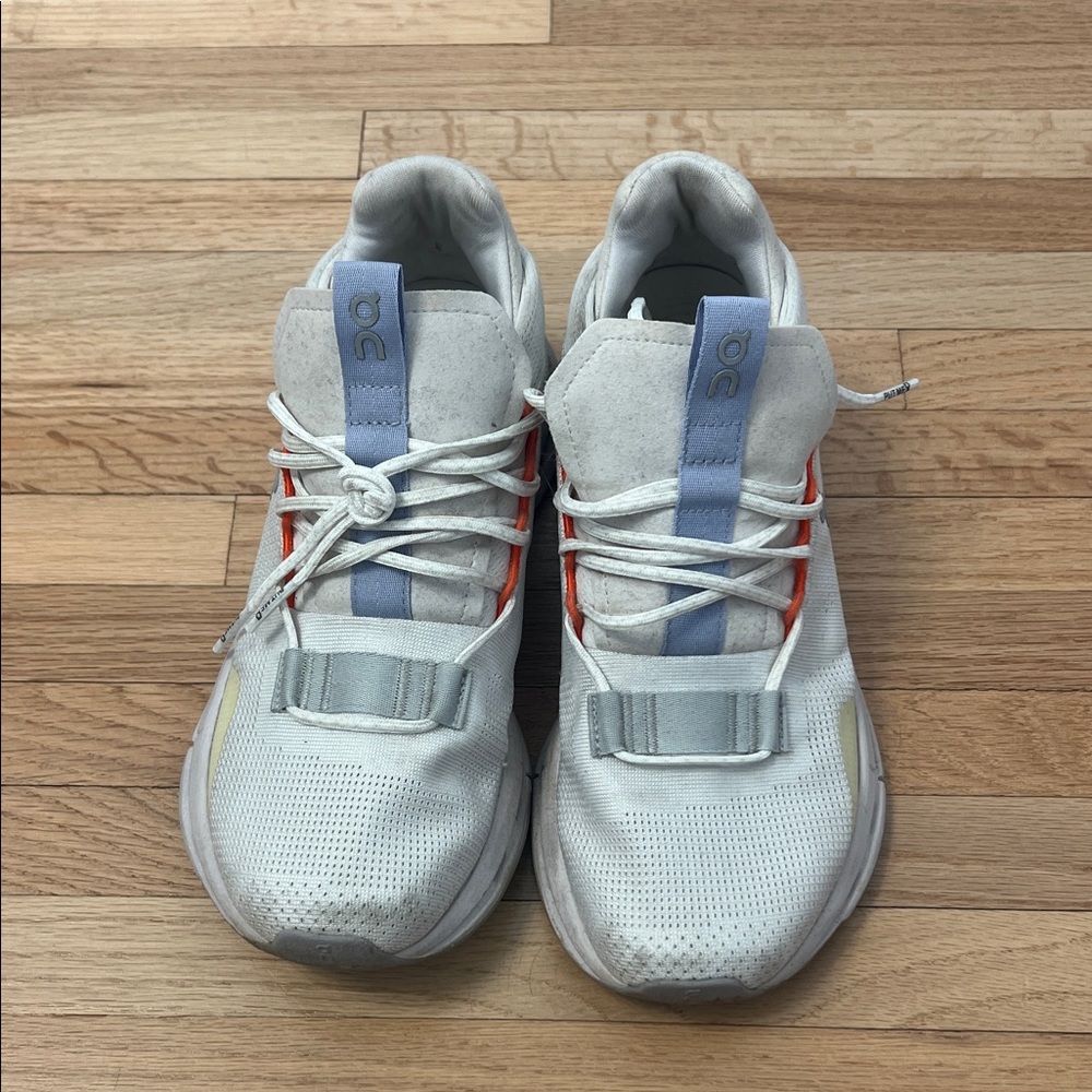 On Running White Sneakers with Blue and Red Accents